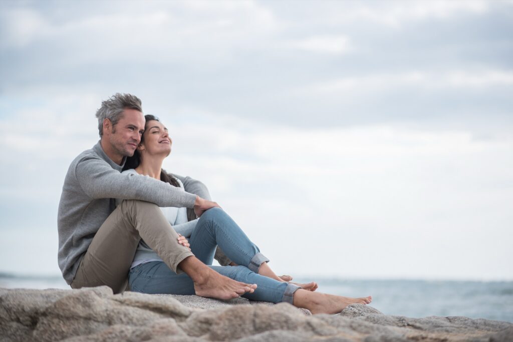 Portrait of a middle-aged couple sitting on the beach