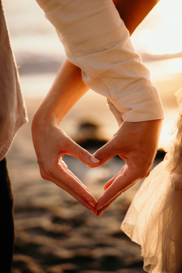 Young couple embracing in a heart shape, symbolizing love and affection