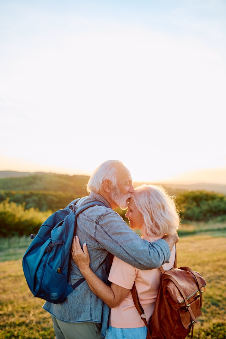 Senior couple sharing an affectionate moment hiking outdoors