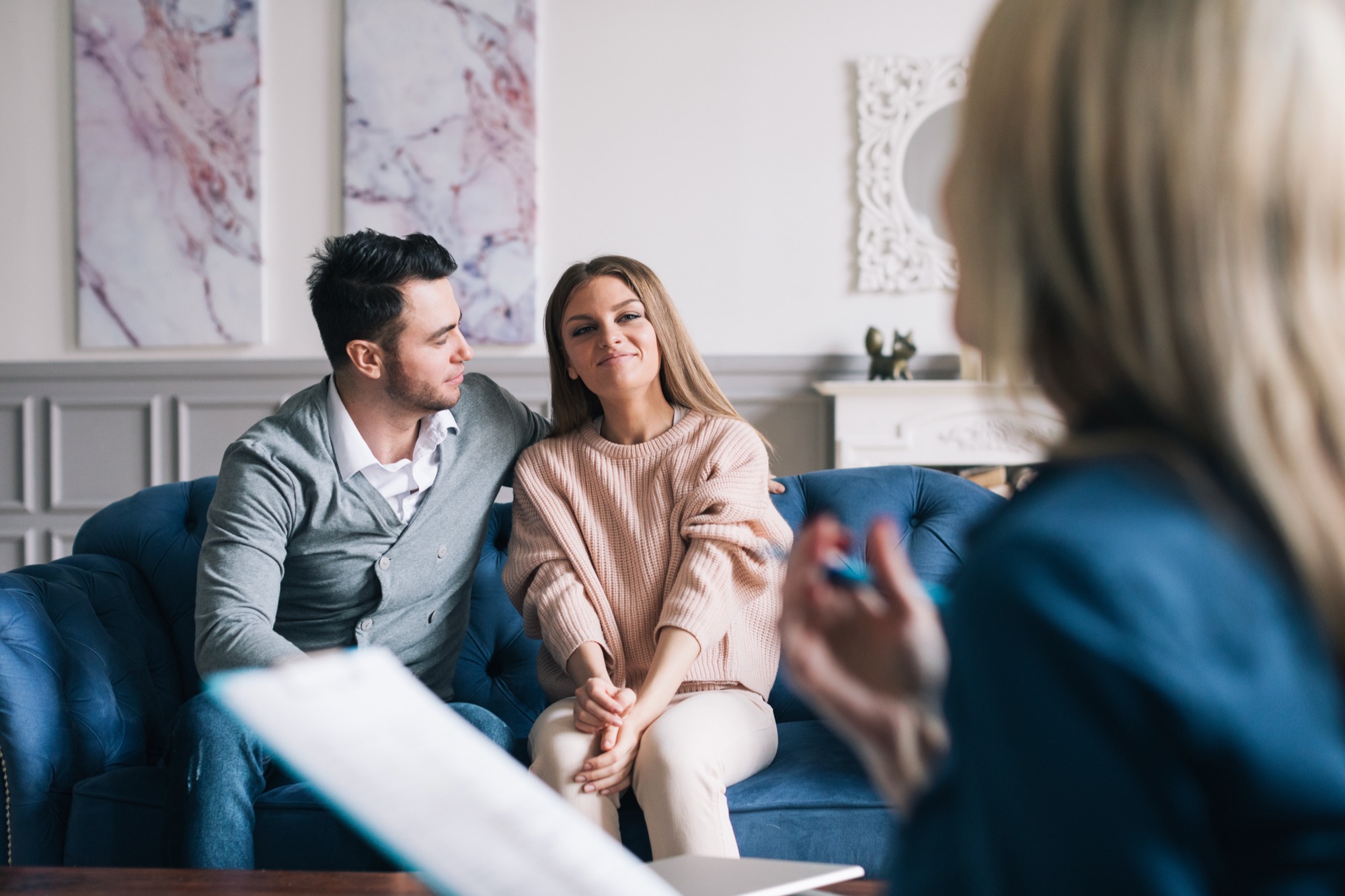 Psychological consultation. Beautiful and happy young couple visiting psychologist for relationship counseling.